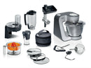 Bosch MUM58359 Series 4 kitchen machine with full accessories—blender, shredder, citrus press, meat grinder, discs, tools and bag.